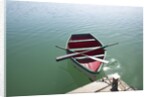 Rowing boat moored at the end of a jetty by Anonymous