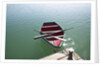 Rowing boat moored at the end of a jetty by Anonymous