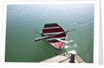 Rowing boat moored at the end of a jetty by Anonymous