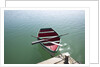 Rowing boat moored at the end of a jetty by Anonymous