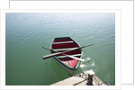 Rowing boat moored at the end of a jetty by Anonymous