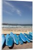 View of stacked up surfboards at the beach by Anonymous