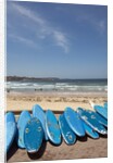 View of stacked up surfboards at the beach by Anonymous