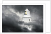 Lighthouse Emerging From Dark Clouds by Anonymous