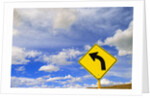 Curve Road Sign on Highway Against Sky by Anonymous