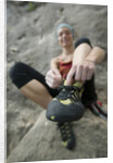 Woman Putting on Rock Climbing Shoes by Anonymous