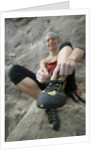 Woman Putting on Rock Climbing Shoes by Anonymous
