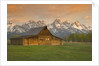 Log Barn in Meadow near Mountain Range by Corbis