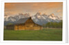 Log Barn in Meadow near Mountain Range by Corbis