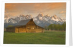 Log Barn in Meadow near Mountain Range by Corbis