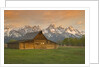 Log Barn in Meadow near Mountain Range by Corbis