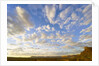 Cumulus Clouds Over Sandstone Buttes at Sunrise by Anonymous