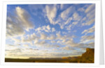 Cumulus Clouds Over Sandstone Buttes at Sunrise by Anonymous