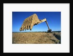 Backhoe Working in Muddy Field by Anonymous