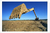 Backhoe Working in Muddy Field by Anonymous