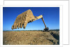 Backhoe Working in Muddy Field by Anonymous