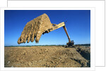 Backhoe Working in Muddy Field by Anonymous