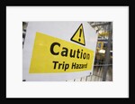 Caution Trip Hazard Sign on Construction Site by Anonymous
