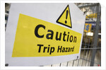 Caution Trip Hazard Sign on Construction Site by Anonymous
