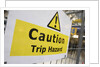 Caution Trip Hazard Sign on Construction Site by Anonymous