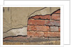 Brick Wall Part Covered By Plaster by Anonymous