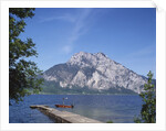 Wooden Boat Tied to Dock on Lake by Anonymous