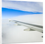 Airplane Wing Above Clouds by Anonymous