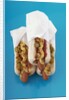 Three hot dogs in buns by Anonymous
