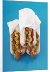 Three hot dogs in buns by Anonymous