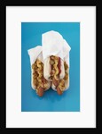 Three hot dogs in buns by Anonymous