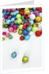 Christmas ornaments on snow by Anonymous