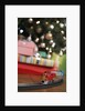 Toy train running beneath Christmas tree by Anonymous