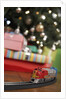 Toy train running beneath Christmas tree by Anonymous