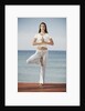 Woman doing yoga by the ocean by Anonymous