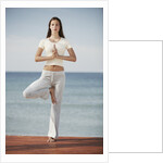 Woman doing yoga by the ocean by Anonymous