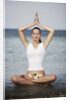 Woman meditating in the ocean by Anonymous