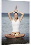 Woman meditating in the ocean by Anonymous