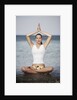 Woman meditating in the ocean by Anonymous