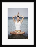 Woman meditating in the ocean by Anonymous