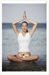 Woman meditating in the ocean by Anonymous