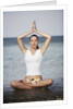 Woman meditating in the ocean by Anonymous