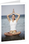 Woman meditating in the ocean by Anonymous