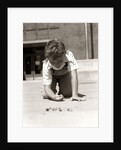1950s Boy Ready To Shoot Kneeling On School Yard Ground Playing Game Of Marbles by Anonymous