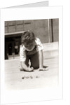 1950s Boy Ready To Shoot Kneeling On School Yard Ground Playing Game Of Marbles by Anonymous