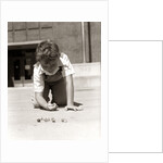 1950s Boy Ready To Shoot Kneeling On School Yard Ground Playing Game Of Marbles by Anonymous