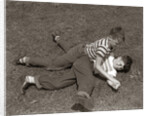1950s Two Boys Wear Tee Shirts Blue Jeans Playing Rough Fighting Wrestling On The Grass by Anonymous