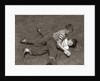 1950s Two Boys Wear Tee Shirts Blue Jeans Playing Rough Fighting Wrestling On The Grass by Anonymous