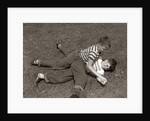 1950s Two Boys Wear Tee Shirts Blue Jeans Playing Rough Fighting Wrestling On The Grass by Anonymous