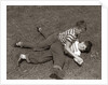 1950s Two Boys Wear Tee Shirts Blue Jeans Playing Rough Fighting Wrestling On The Grass by Anonymous