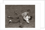 1950s Two Boys Wear Tee Shirts Blue Jeans Playing Rough Fighting Wrestling On The Grass by Anonymous